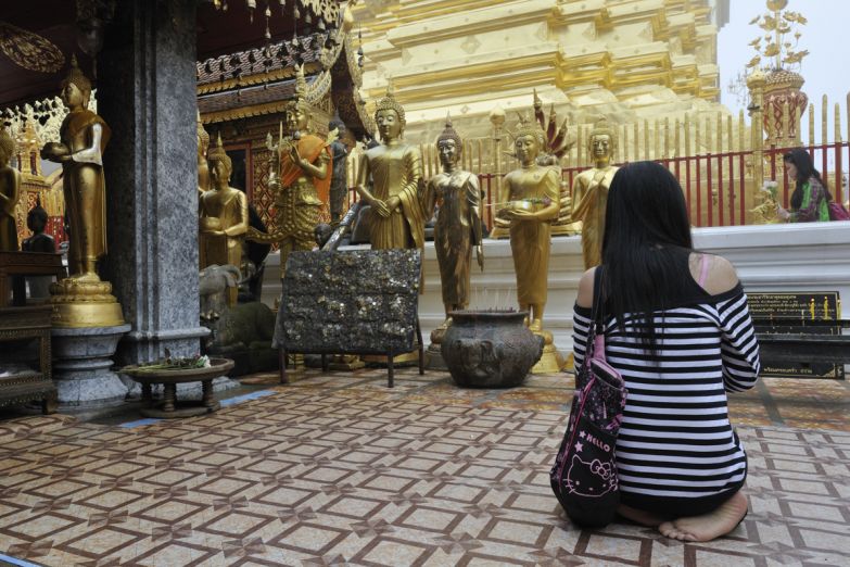 Девушка молится в храме Изумрудного Будды